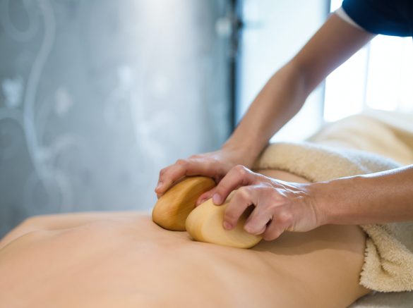 Thai massage therapist treating patient